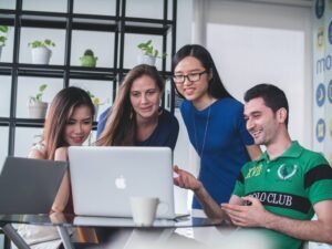 students gathered around laptop